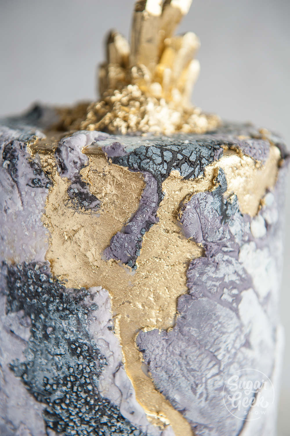 close up of stone texture cake with gold