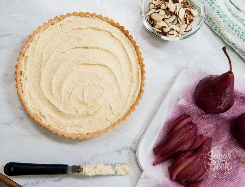 making a wine poached pear frangipane tart