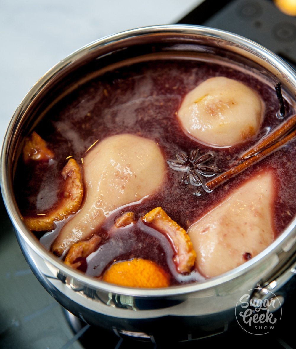 pears in poaching liquid with orange peel, star anise and cinnamon sticks