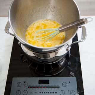 heat eggs and sugar over simmering water until sugar is dissolved