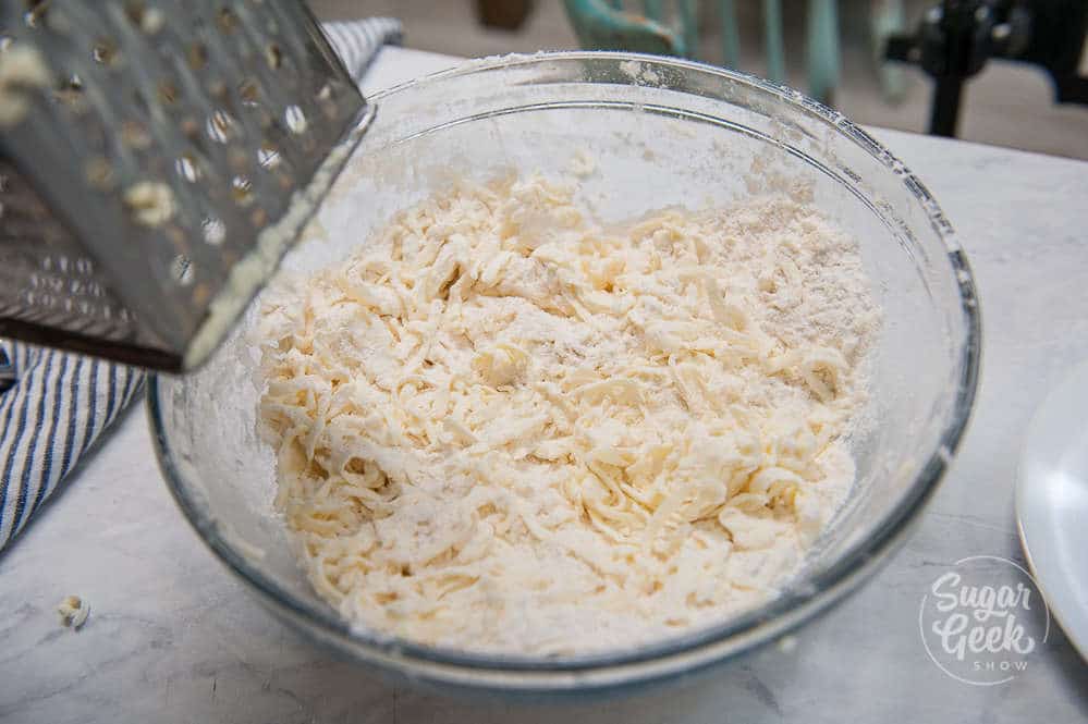 grating cold butter into the flour mixture helps keep the butter cold while you work