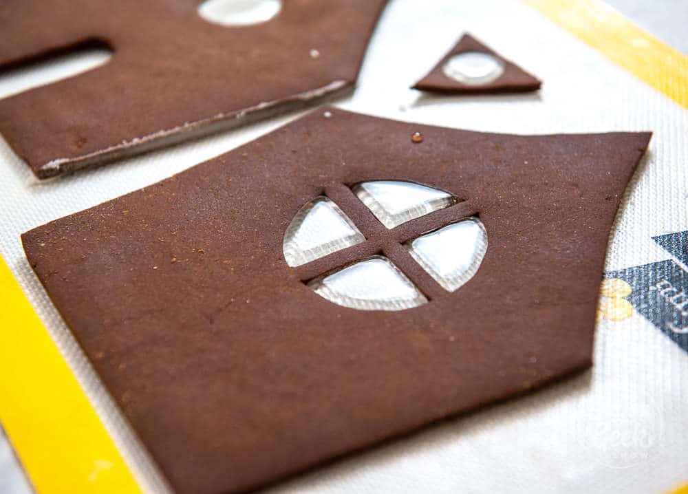 pouring isomalt in gingerbread pieces to make windows