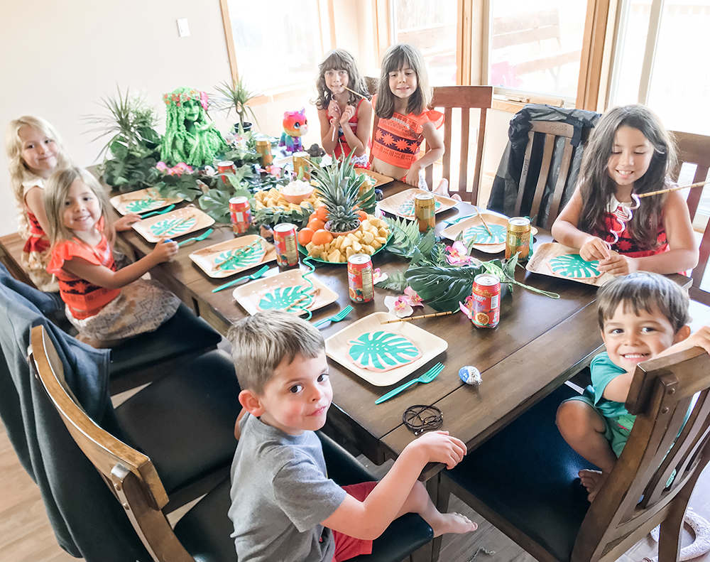 children at a hawaiian-themed birthday party sitting at a table