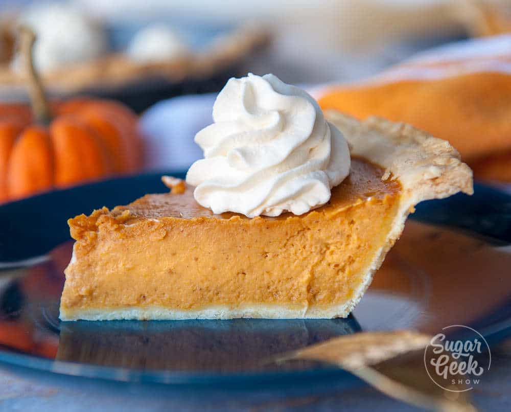 pumpkin pie slice with stabilized whipped cream on top