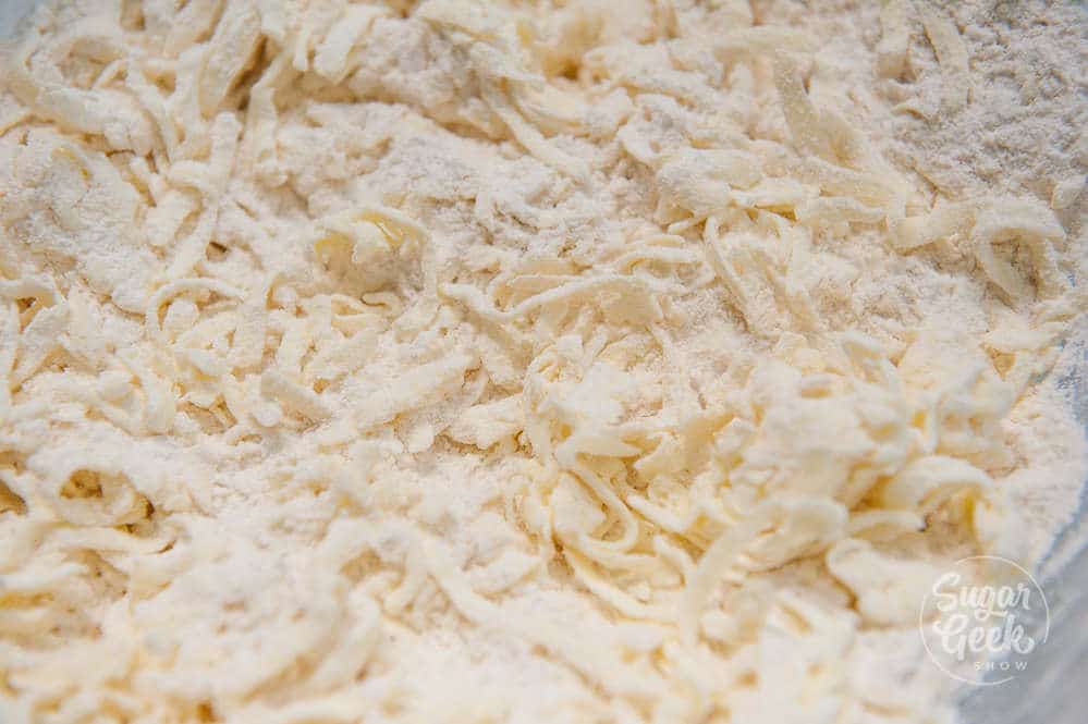 Cold butter mixed into the flour and salt mixture until it looks like coarse sand.