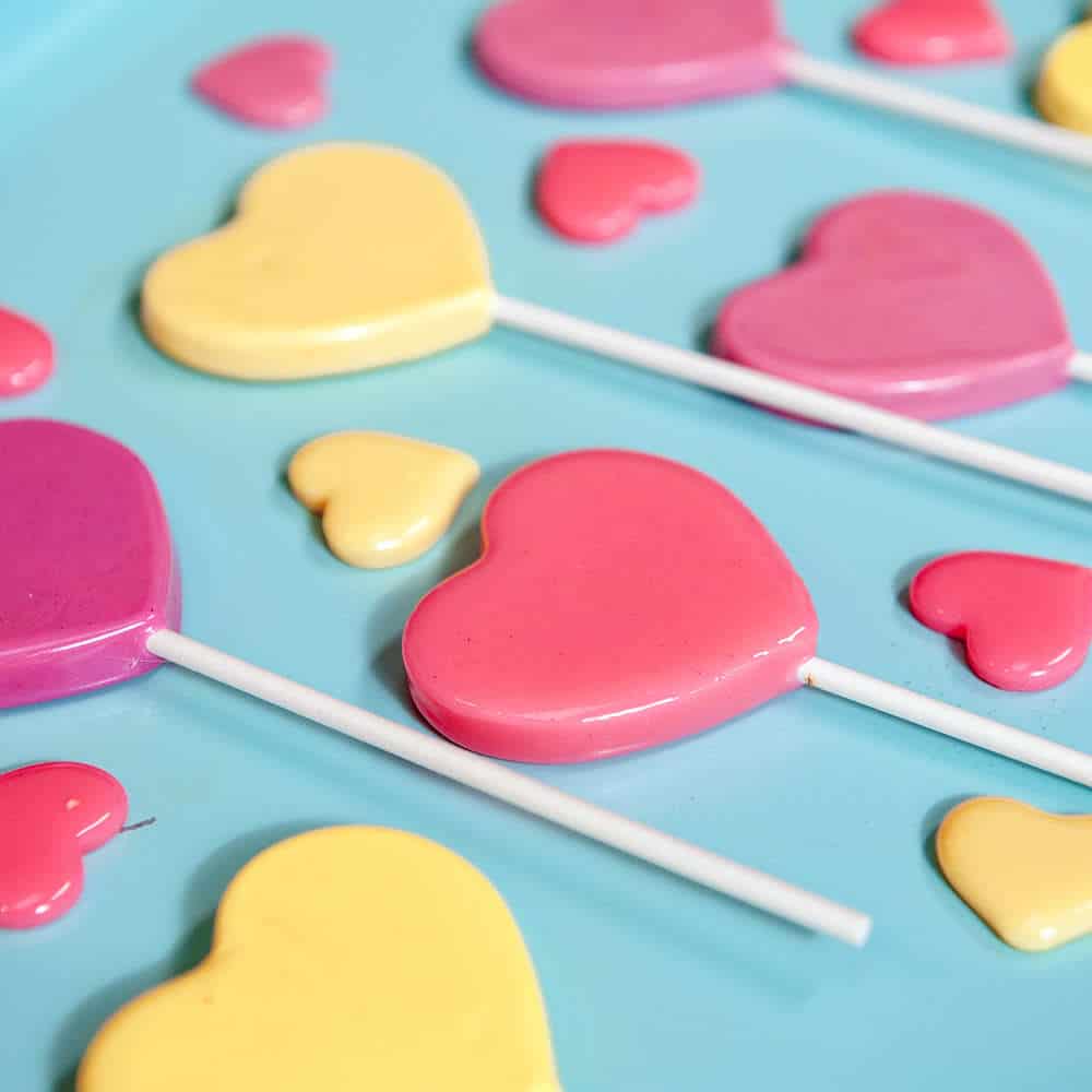 heart lollipops on a blue background