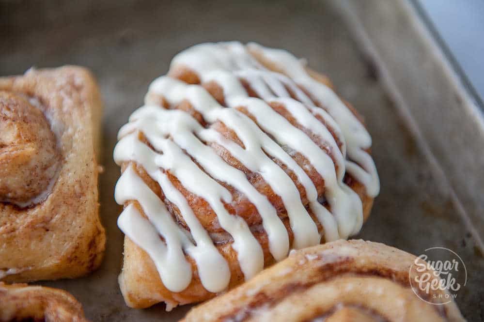 frosting on a homemade cinnamon roll
