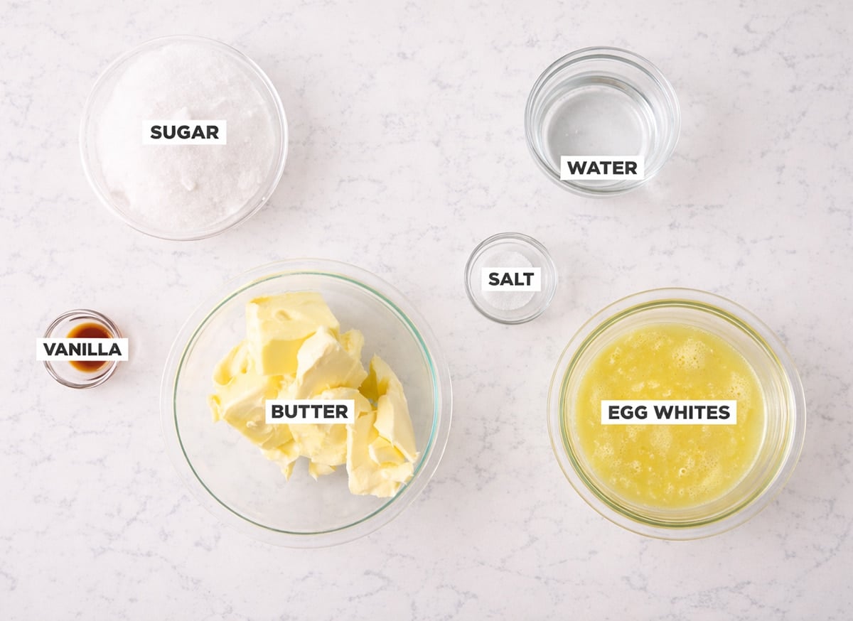 Italian meringue buttercream ingredients in bowls on a white countertop.