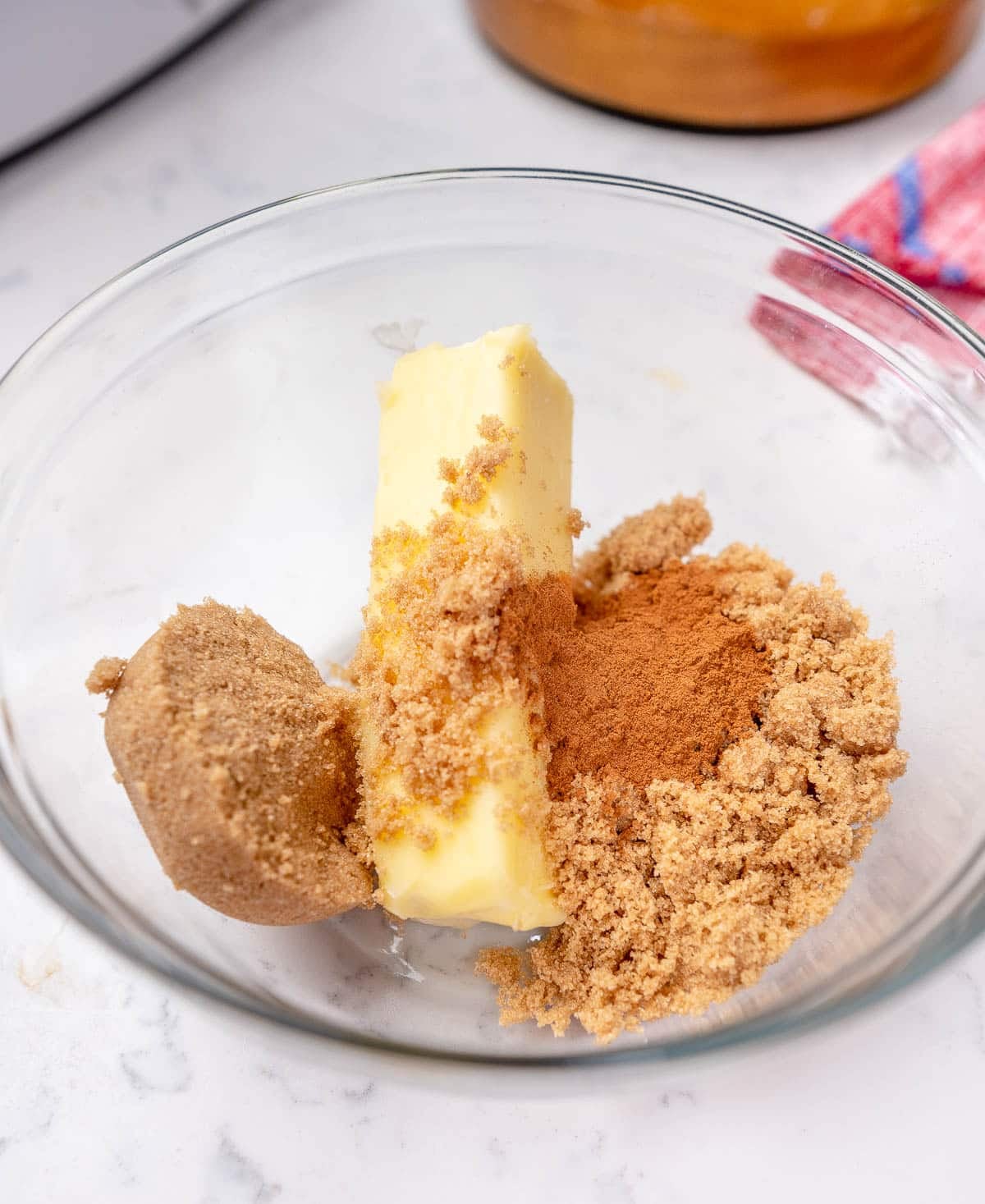 Cinnamon roll filling ingredients in a clear glass bowl.