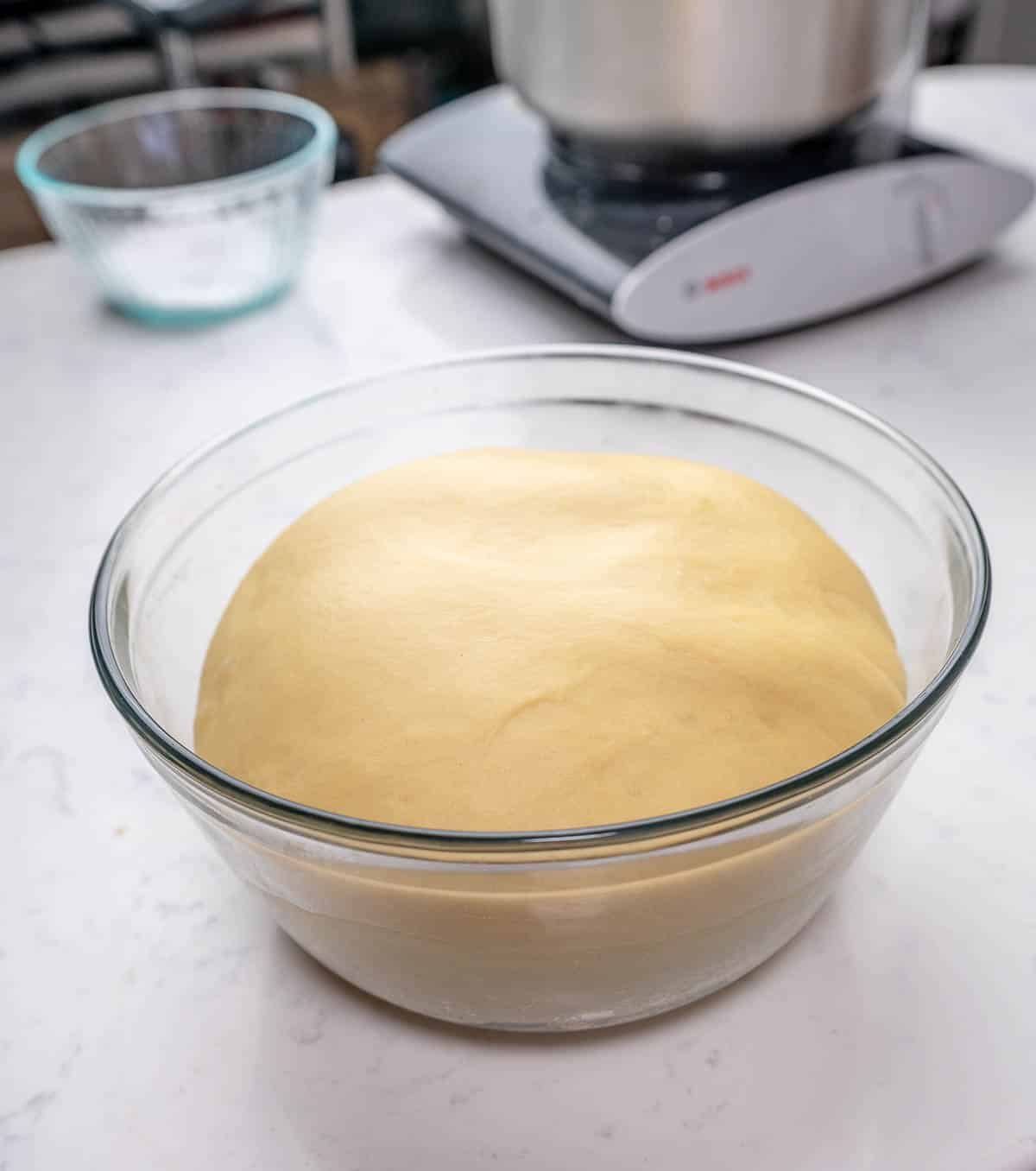 sweet dough in a glass bowl