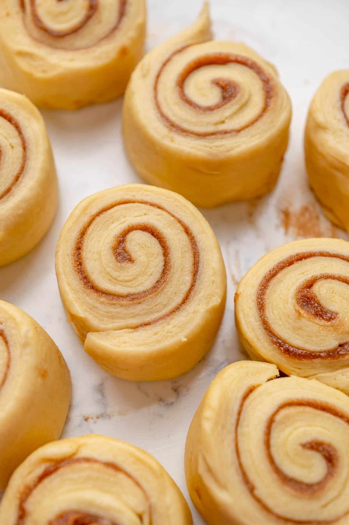 close up of sliced cinnamon rolls in a pan