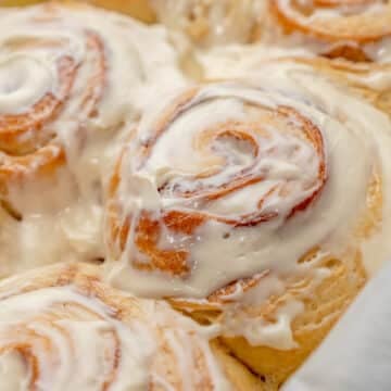 close up of cinnamon rolls with cream cheese frosting