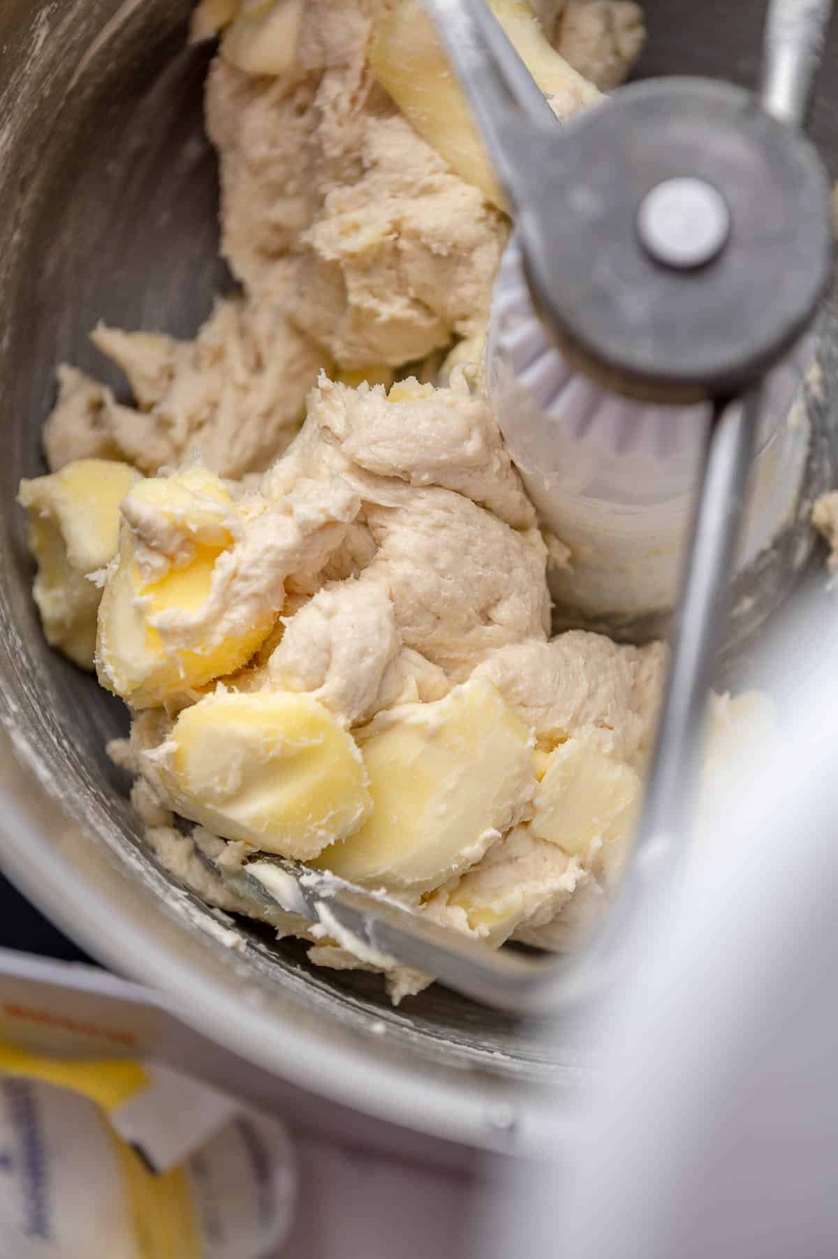 cinnamon roll recipe ingredients in the bowl of a mixer