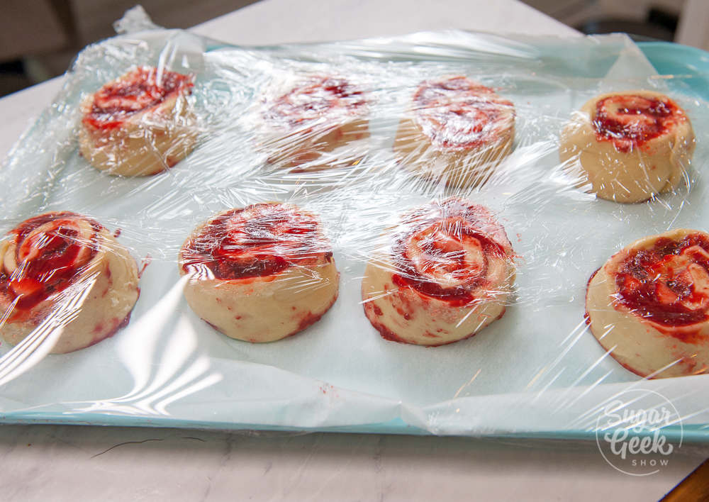 strawberry cinnamon rolls wrapped in plastic wrap