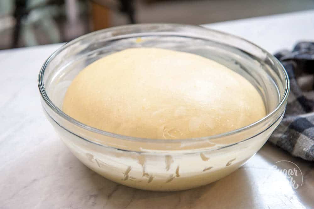 photo of cinnamon roll dough proofing in a bowl