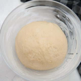 place dough in a greased bowl and cover with a tea towel