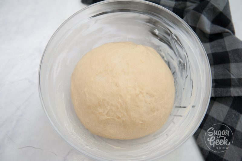 place dough in a greased bowl and cover with a tea towel