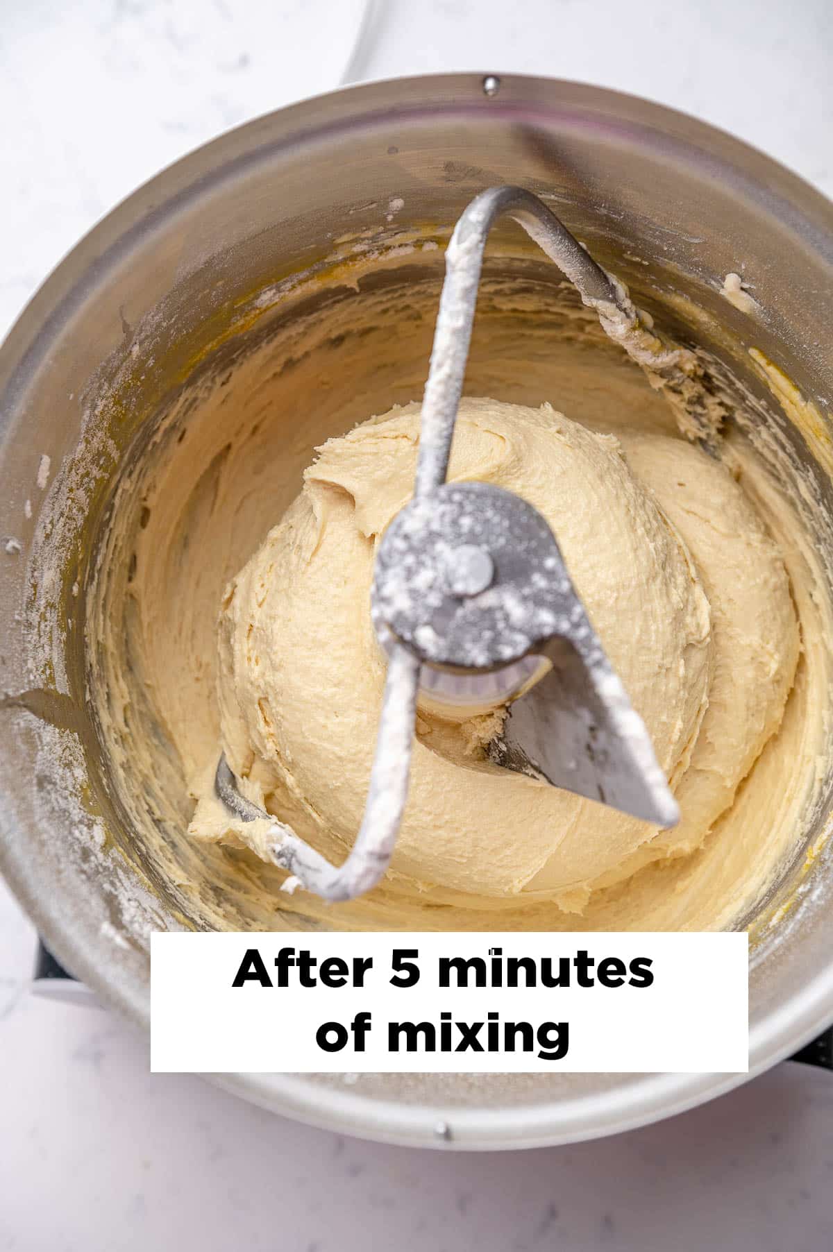 shot of cinnamon roll dough in a mixing bowl shot from above