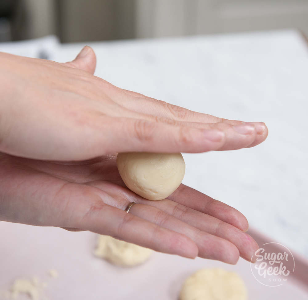 cookie dough rolled between hands