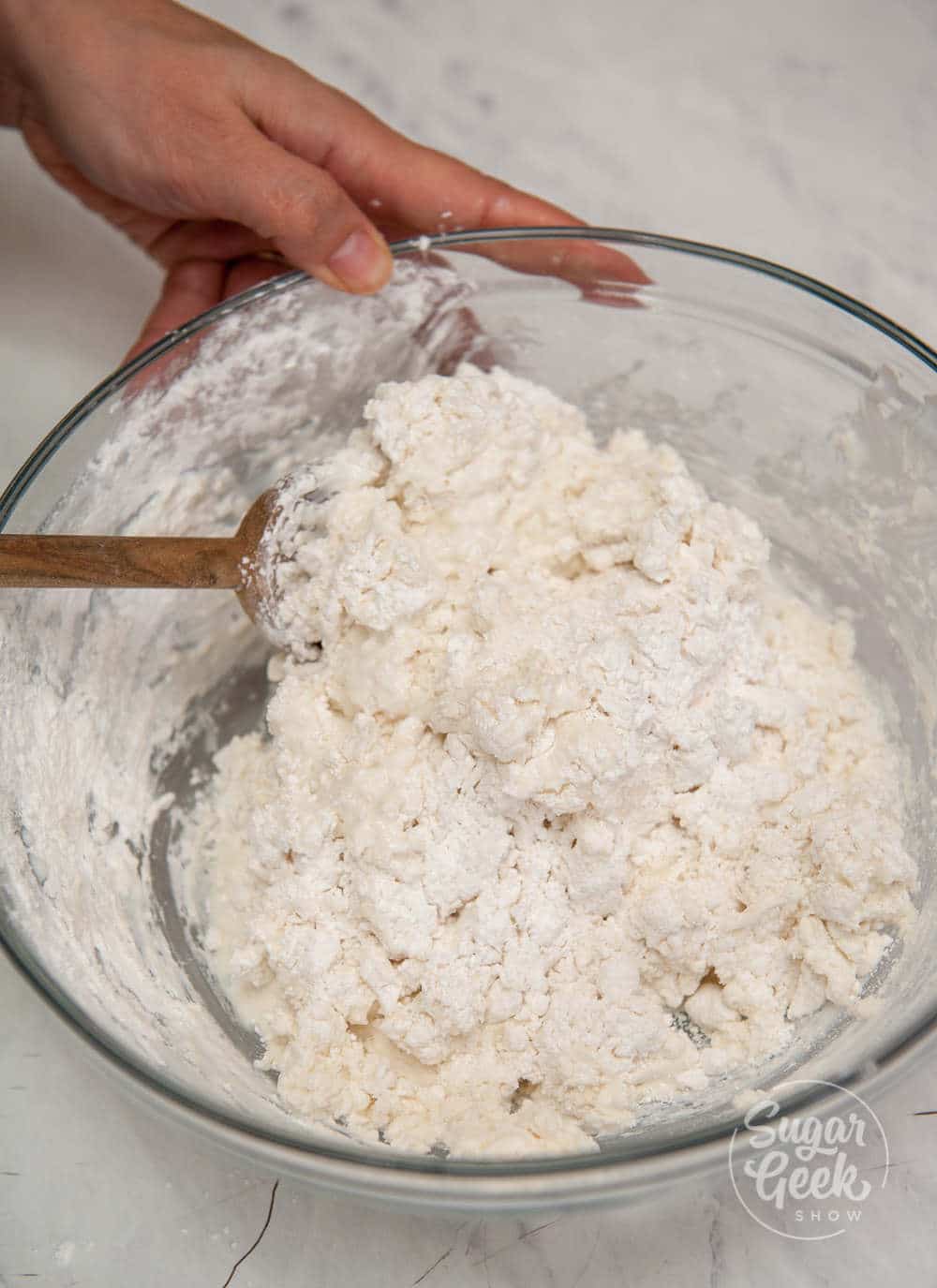 making traditional irish soda bread in a bowl with a wooden spoon