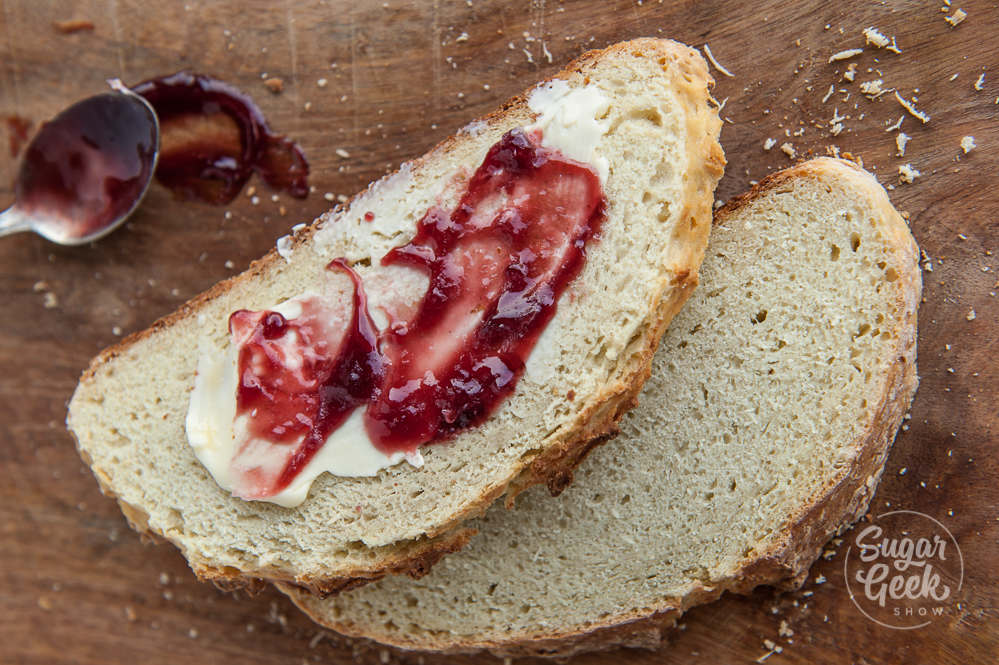 two slices of traditional irish soda bread with jam and butter spread on top