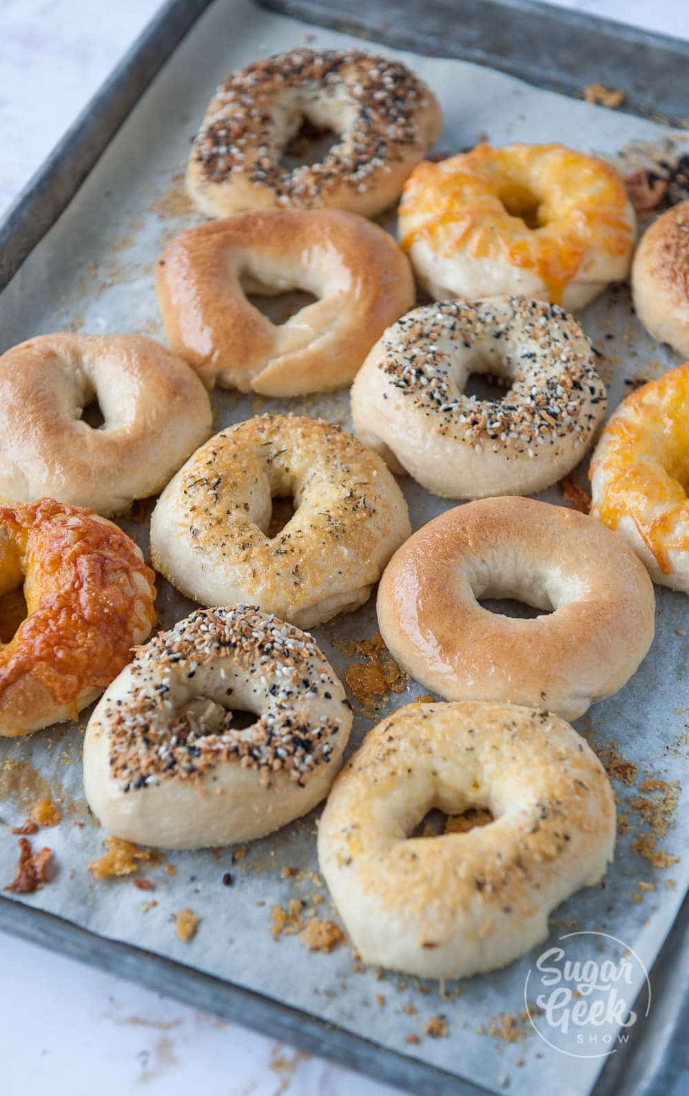 Homemade bagels baked on a pan.