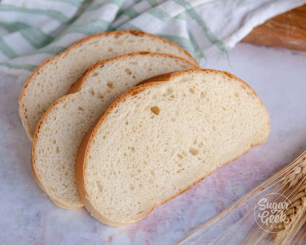 three slices of homemade bread on a white background