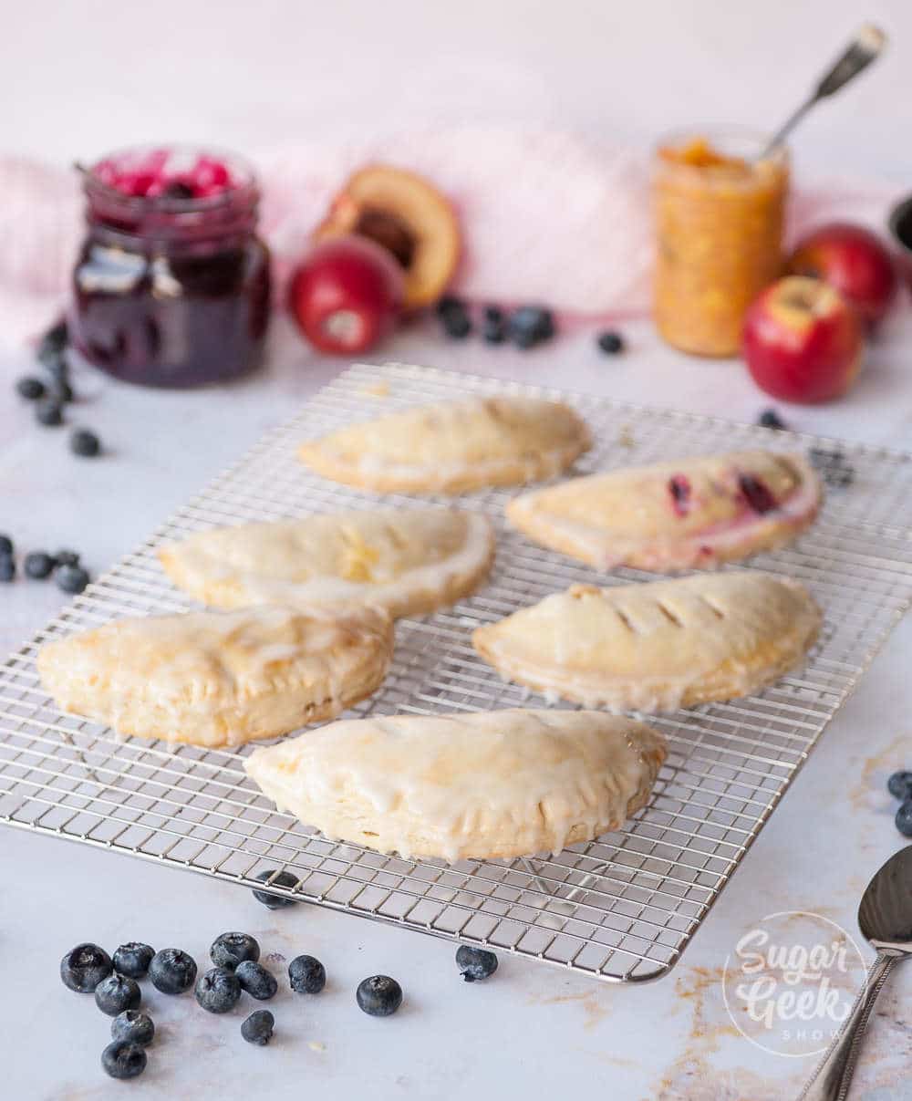 hand pies on a cooling rack with ingredients surrounding them