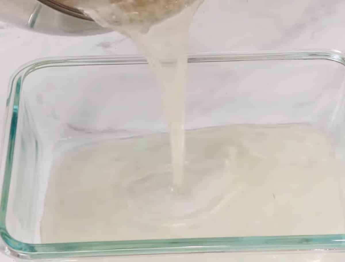 Pouring kohakutou mixture into a rectangular glass dish.