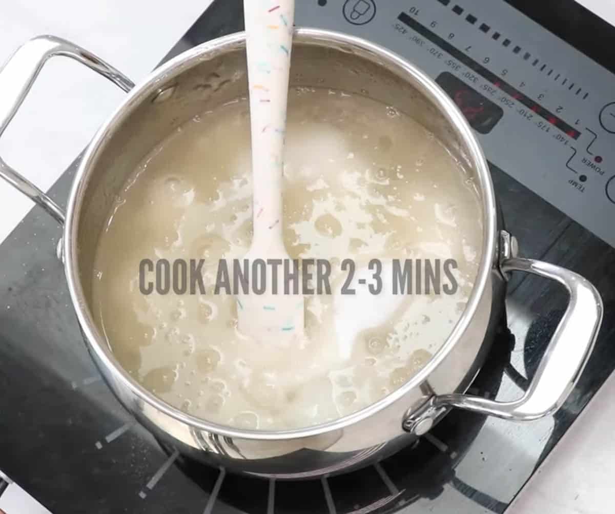 Simmering agar agar powder and water in a metal saucepan.