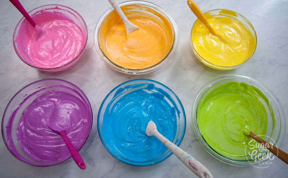 6 bowls of white velvet cake all colored rainbow