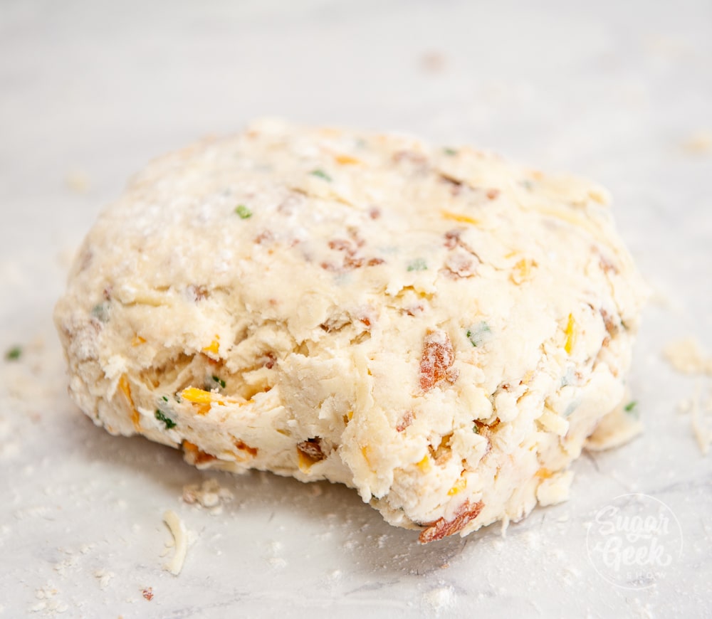 cheddar bacon chive biscuit dough folded over onto itself