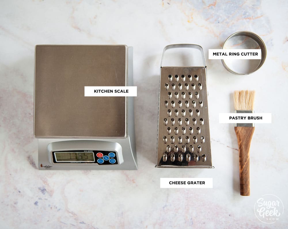 tools needed to make bacon cheddar chive biscuits on white background