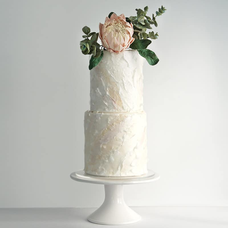 King Protea sugar flower and eucalyptus sugar foliage on white wafer paper wedding cake