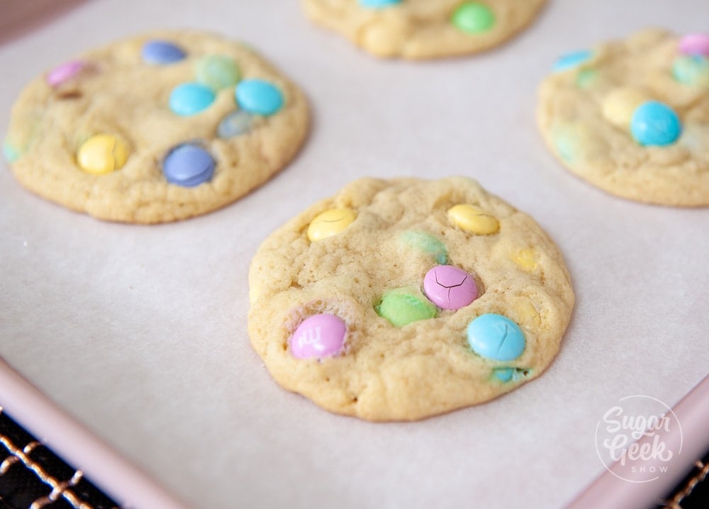 M&M cookies cooling on parchment paper