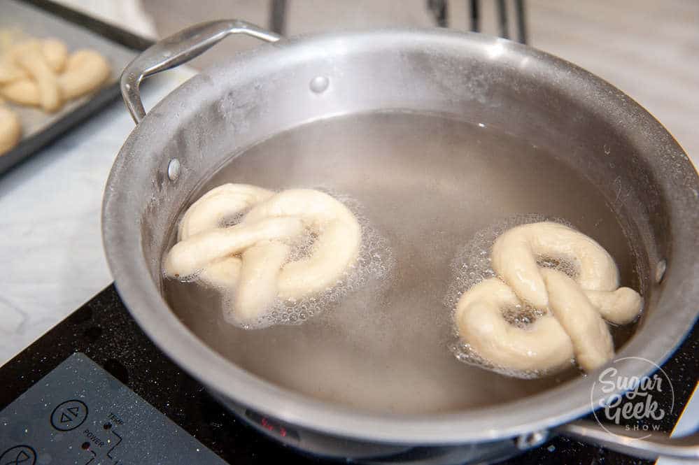 boiling soft pretzels in a baking soda and water bath for 20 seconds