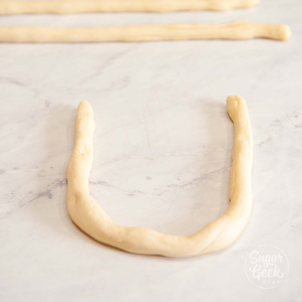 shape pretzel dough snake into a U 