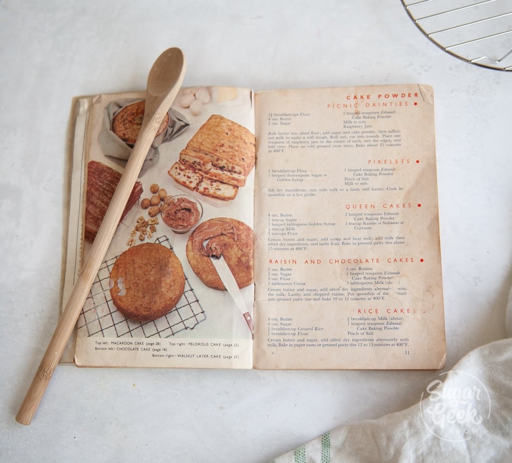 edmonds cookery book open on white background with wooden spoon on top