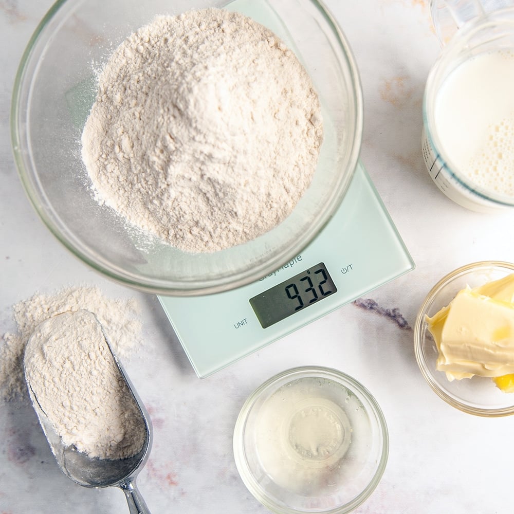 ingredients in clear bowls surrounding digital kitchen scale