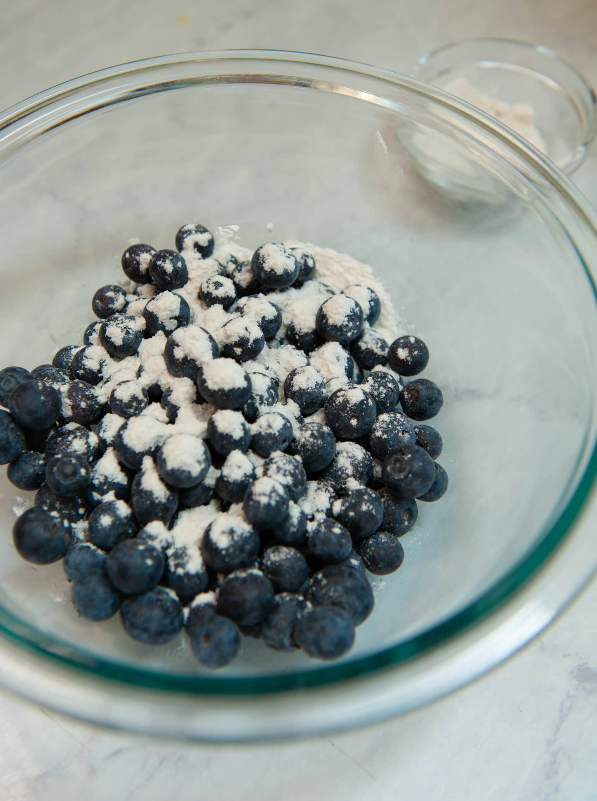 berries being mixed with flour