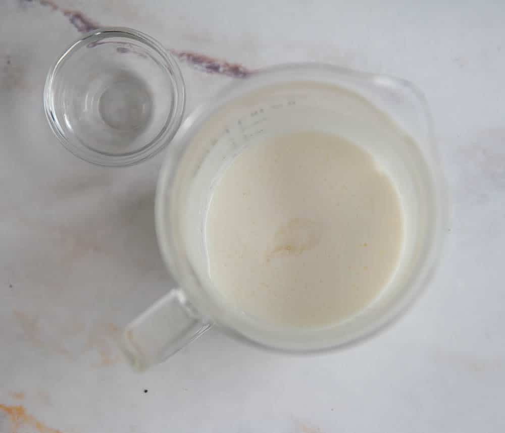milk and vanilla in clear measuring cup shot from above