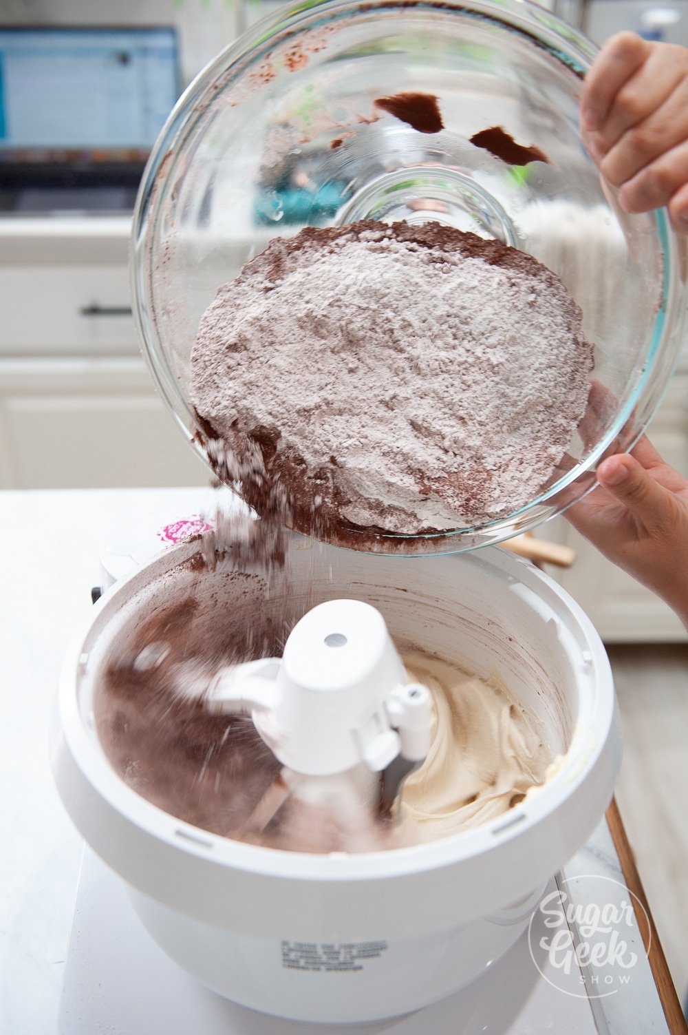 adding dry ingredients to cake batter
