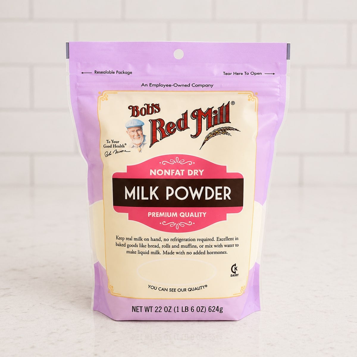 Package of milk powder on a white countertop.