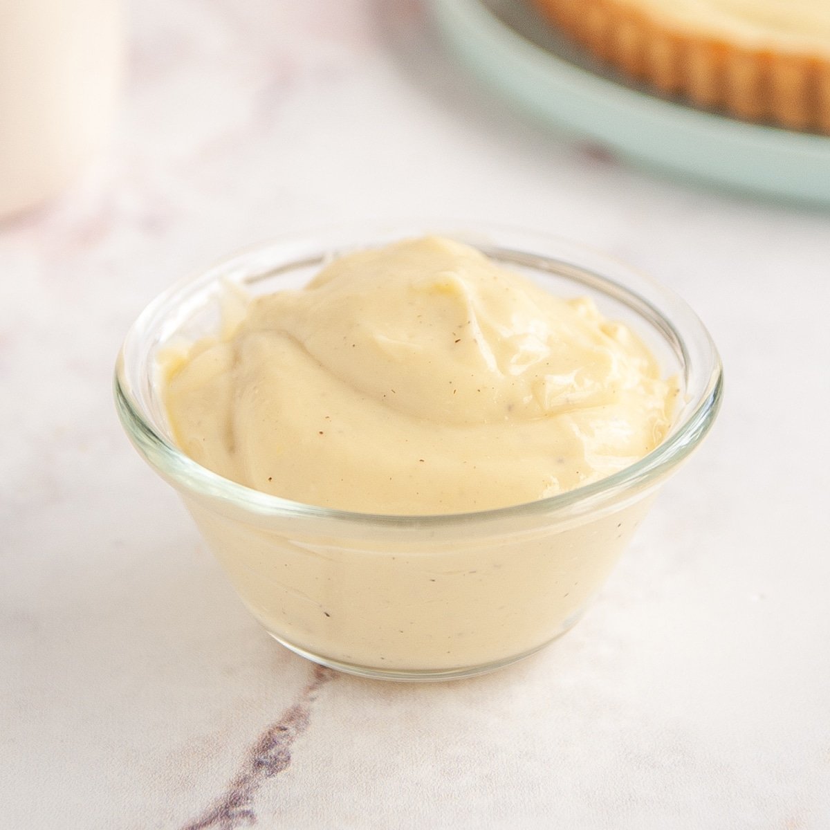 pastry cream in clear glass bowl on white background