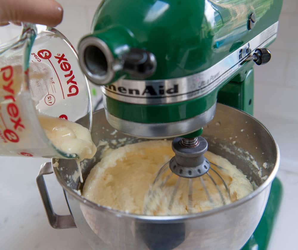 pouring melted buttercream into cold buttercream