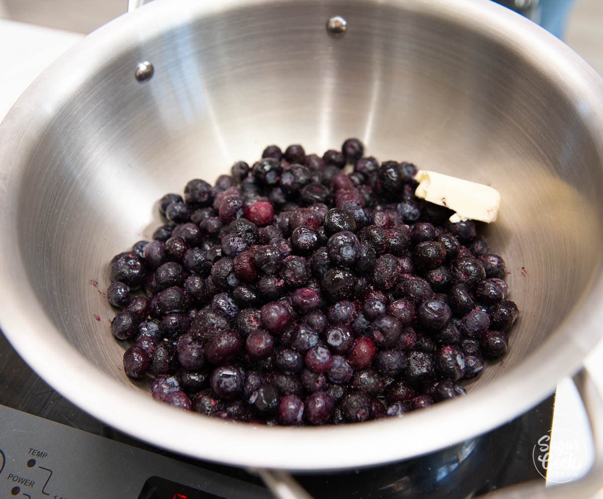 blueberries in a stainless steel pot with butter