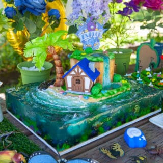 sculpted animal crossing cake sitting on a table with presents and decorations surrounding it
