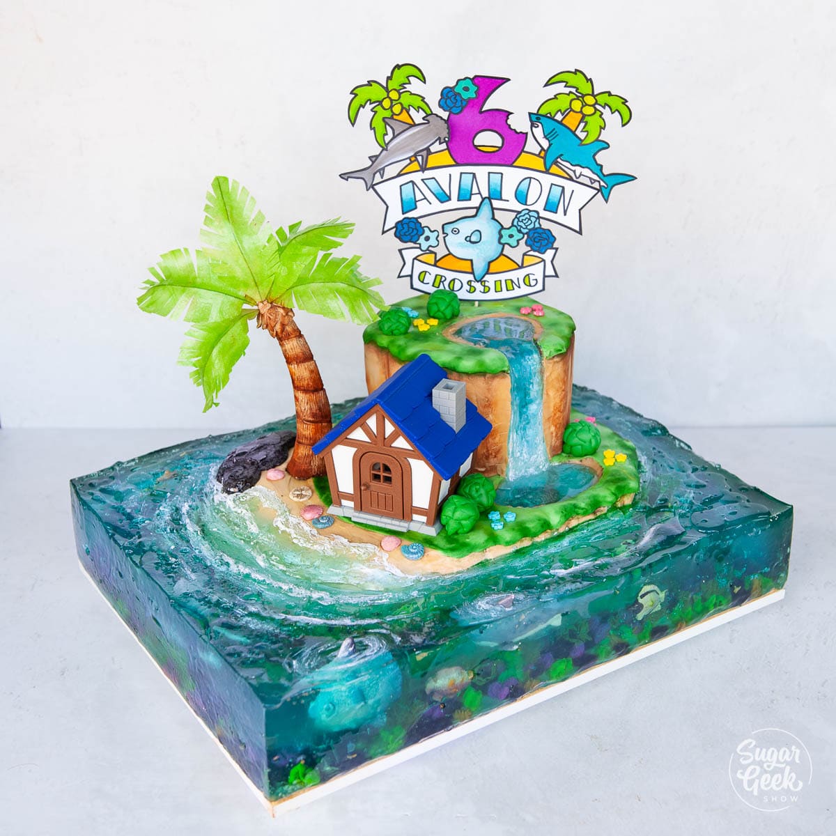 animal crossing cake with jelly ocean and paper sign topper