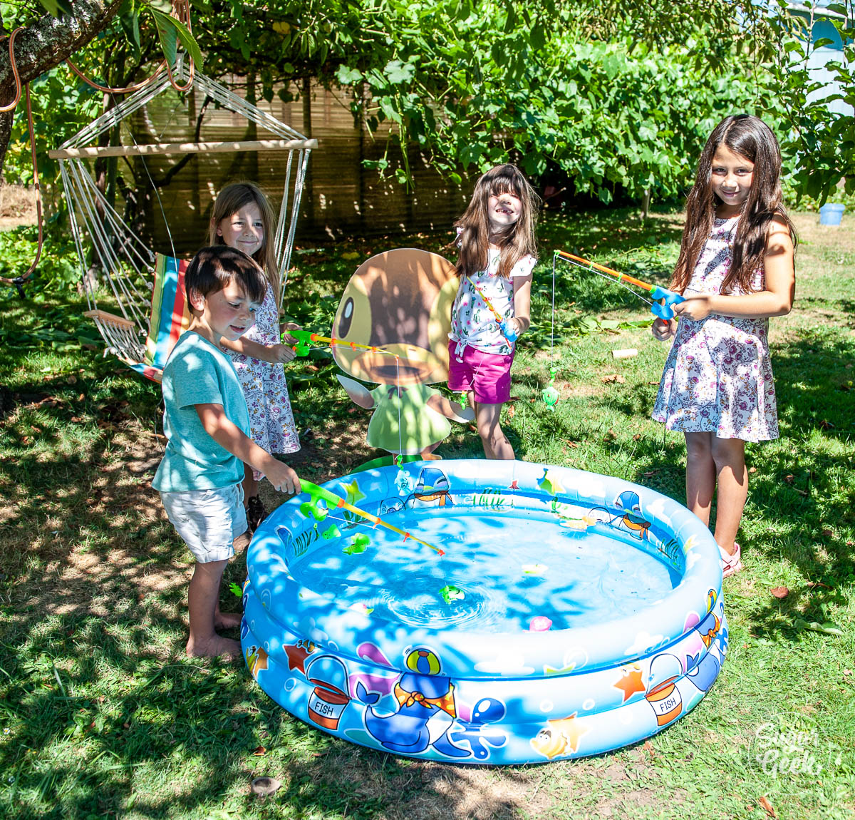 kids fishing with toy fishing poles in a kiddie pool