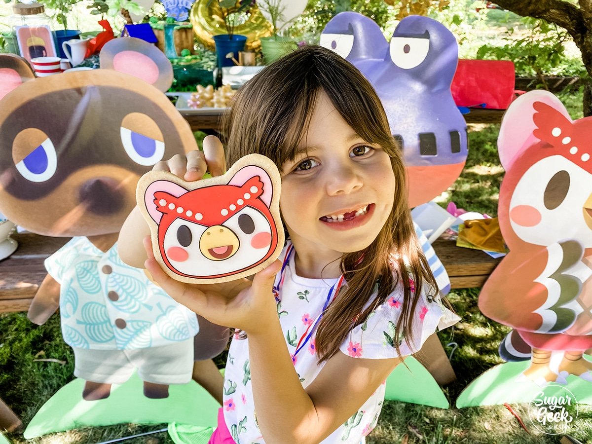 little girl holding a celeste sugar cookie